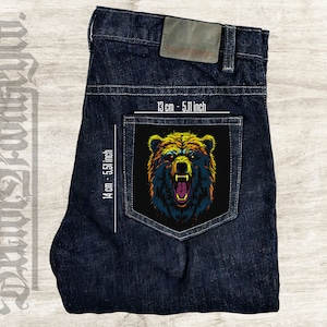 May include: A dark blue denim jean pocket with a colorful bear face patch. The patch is 5.11 inches wide and 5.51 inches tall.
