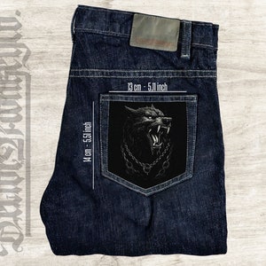 May include: A dark blue denim jean with a black patch on the back pocket. The patch features a snarling wolf with a chain around its neck. The patch measures 5.51 inches by 5.11 inches.