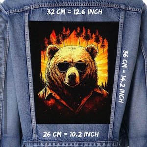 May include: A denim jacket with a patch featuring a brown bear wearing sunglasses in front of a sunset with trees. The patch measures 32 cm by 36 cm.