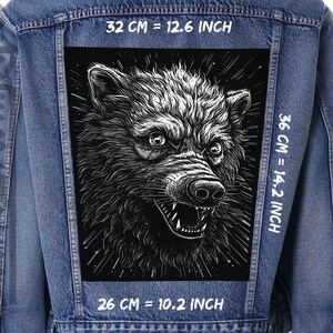 May include: A black and white illustration of a wolf's head on a black background. The wolf is snarling with its mouth open and teeth showing. The image is 36 cm by 26 cm, or 14.2 inches by 10.2 inches.