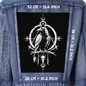 May include: A denim jacket with a large black patch featuring a white raven perched on a branch, surrounded by geometric shapes. The patch measures 12.6 inches wide by 14.2 inches high.
