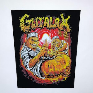 May include: A black patch featuring a grotesque illustration. Two figures in prison uniforms are depicted, one giving the middle finger. The word "GUTALAX" is in yellow, stylized lettering. The figures are in shades of orange and yellow.