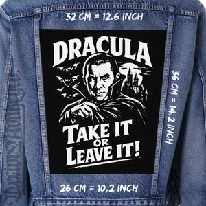 May include: A denim jacket with a large black patch featuring a portrait of Dracula, bats, and a castle. The text reads "DRACULA TAKE IT OR LEAVE IT!" Patch dimensions are 26 cm by 36 cm.