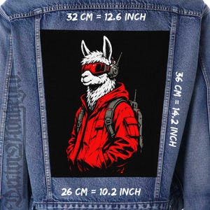 May include: A blue denim jacket featuring a large rectangular patch on the back. The patch displays a white llama wearing red goggles and a red hooded jacket with a backpack. The patch measures 10.2 inches wide by 14.2 inches high.