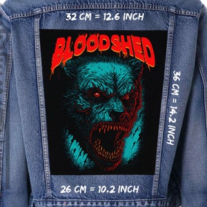 May include: A denim jacket with a black patch featuring a snarling blue and green wolf with red eyes and the word "BLOODSHEDD" in red letters. The patch is 26 cm by 36 cm.