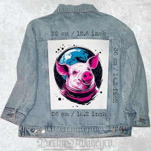 May include: Light blue denim jacket with a large graphic of a pig in space. The pig is pink and white, with a blue planet in the background. The graphic measures 12.6 inches wide, 14.2 inches tall, and 10.2 inches long.