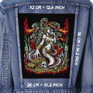 May include: A blue denim jacket featuring a large rectangular back patch with a graphic illustration of a multi-headed snake creature and a figure surrounded by treasure, skulls, and flames. The patch measures 12.6 inches by 14.2 inches by 10.2 inches.