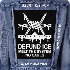 May include: A blue denim jacket with a large black patch. The patch features white barbed wire, a building silhouette, and the text "DEFUND ICE, MELT THE SYSTEM, NO CAGES." Patch dimensions are 12.6 inches by 14.2 inches.