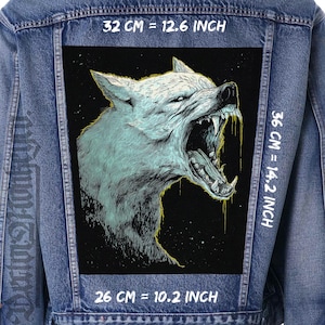 May include: A denim jacket with a large, rectangular patch featuring a detailed illustration of a snarling wolf. The wolf is rendered in shades of gray and blue with yellow accents. The patch measures 12.6 inches wide, 14.2 inches high, and 10.2 inches long.