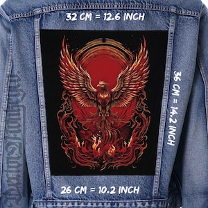 May include: A denim jacket with a large, rectangular patch featuring a phoenix design. The phoenix is depicted with outstretched wings in shades of red and gold against a black background. The patch measures 32 cm wide, 36 cm high, and 26 cm deep.