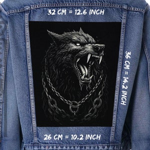 May include: A black denim jacket with a large black and white wolf graphic patch on the back. The patch is 12.6 inches wide, 14.2 inches tall, and 10.2 inches deep. The text "32 CM = 12.6 INCH", "36 CM = 14.2 INCH", and "26 CM = 10.2 INCH" is printed on the jacket.