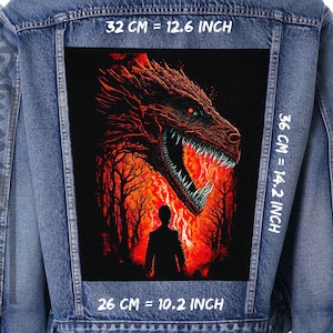 May include: A denim jacket with a black patch featuring a red dragon with flames and a person standing in front of it. The patch is 32 cm wide, 36 cm tall, and 26 cm deep.