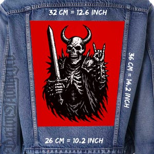 May include: A denim jacket with a large, rectangular patch featuring a black and white illustration of a horned skeleton warrior holding a sword and making a rock-and-roll hand gesture. The patch is 12.6 inches wide, 14.2 inches tall, and 10.2 inches long.