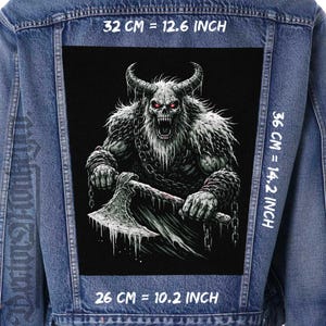 May include: A denim jacket with a large, black patch featuring a detailed illustration of a horned, monstrous figure with glowing red eyes, holding an axe. The patch measures 12.6 inches by 14.2 inches and 10.2 inches. The jacket is blue.
