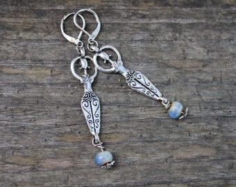 Spiritual earrings with fertility goddess charms and combined with water bleu clay beads