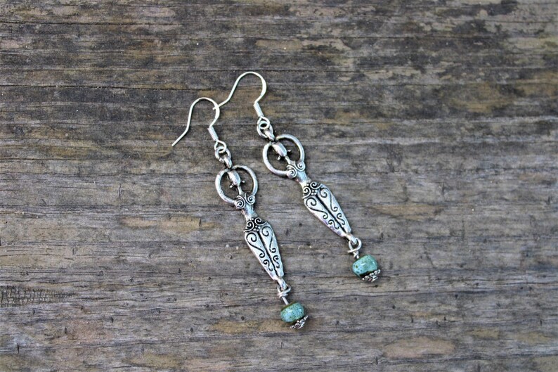 Spiritual earrings with fertility goddess charms and combined with water bleu clay beads