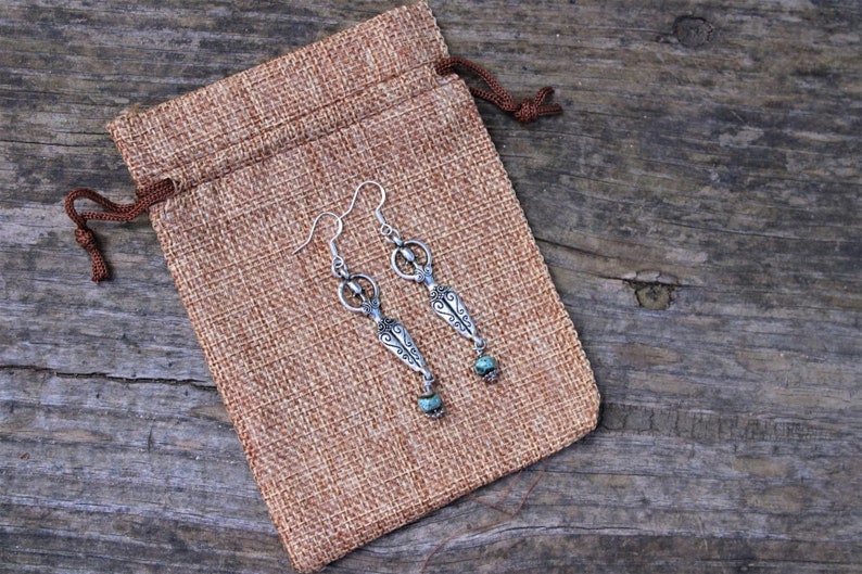 Spiritual earrings with fertility goddess charms and combined with water bleu clay beads