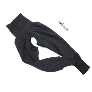 May include: A dark grey turtleneck sweater with long sleeves and a ribbed texture. The sweater is folded in half and the text "anthrazit" is visible in the top right corner.