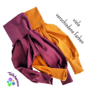 Puede incluir: Dos pares de pantalones suaves y elásticos en color burdeos y amarillo mostaza. Los pantalones tienen un corte holgado y abullonado y están hechos de una tela cómoda. El texto "viele verschiedene Farben" es visible en la imagen.