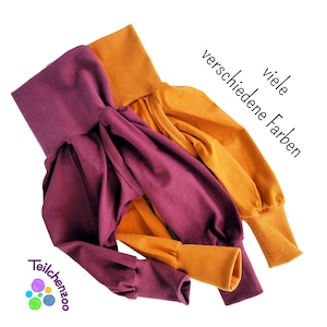 May include: Two pairs of soft, stretchy pants in burgundy and mustard yellow. The pants have a gathered, loose fit and are made of a comfortable fabric. The text "viele verschiedene Farben" is visible in the image.