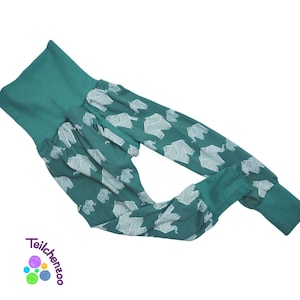 May include: Teal blue pants with a white elephant print. The pants have a wide waistband and a gathered look.