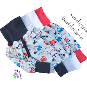 May include: A set of baby leggings with a blue and white fire truck print. The leggings have a navy blue, gray, and red cuff. The text "verschiedene Bündchenfarben" is visible on the image.