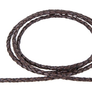 May include: A close-up of a brown braided leather cord. The cord is thick and has a smooth texture.