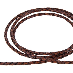 May include: Brown leather cord with a braided design. The cord is approximately 5mm wide.