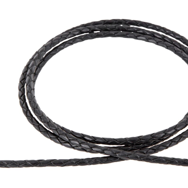May include: Black braided leather cord, a thick, woven cord for jewelry making or crafting.