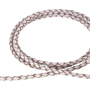 May include: White braided leather cord with a brown undertone. The cord is woven in a simple braid pattern.