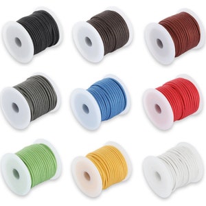 Op de afbeelding: Negen spoelen gekleurd koord in diverse tinten, waaronder zwart, bruin, rood, grijs, blauw, groen, geel en wit. Elke spoel is netjes op een witte plastic kern gewikkeld, met een scala aan opties voor knutselen en sieraden maken.