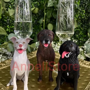 May include: Three dog figurines in gray, brown, and black colors with pink tongues, positioned in front of two clear glass champagne flutes. The left flute is etched with Groom and the right flute is etched with Bride, both featuring script text.
