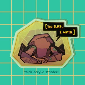 May include: A thick acrylic standee featuring a brown, angular, robotic character with a speech bubble containing the text [YOU SLEEP, I WATCH.]. The character is set against a yellow geometric background with a light green border and grid pattern.