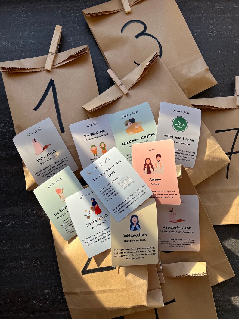 May include: A set of colorful cards with illustrations and text in Arabic and German. The cards feature Islamic themes and concepts, such as the five pillars of Islam, the Shahada, and the meaning of halal and haram. The cards are arranged on brown paper bags with numbers written on them.