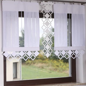 May include: White sheer curtains with a diamond pattern valance. The curtains are hung on a silver curtain rod.