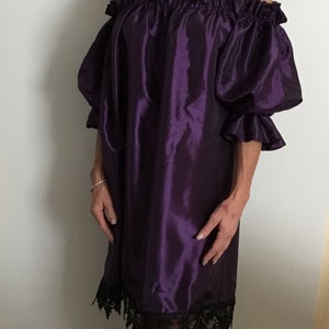 Stunning purple taffeta and black lace trim ladies special event dress. Mid length ruffled sleeves. On or off the shoulder ruffled neckline