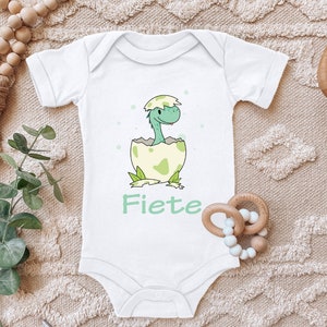Baby Body "Baby Dini, dinosaur hatches from the egg, personalized with desired name" saying gift for birth for birthday cotton