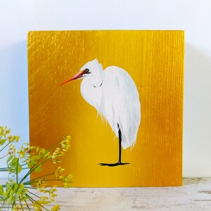 Painted great egret on wood, white heron on golden background
