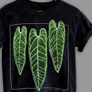 May include: Black t-shirt with a graphic of three green leaves with a white outline. The text "KILL ONLY TIME" is printed on the bottom of the shirt.