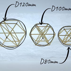 May include: Three geometric wire sculptures made of thin gold-toned metal rods arranged in a spherical lattice structure. The sculptures are labeled with diameters of D120mm, D100mm, and D80mm, indicating their respective sizes in millimeters.
