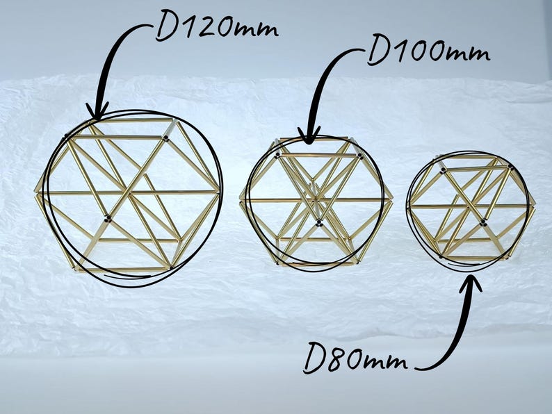 May include: Three geometric wire sculptures made of thin gold-toned metal rods arranged in a spherical lattice structure. The sculptures are labeled with diameters of D120mm, D100mm, and D80mm, indicating their respective sizes in millimeters.