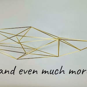 May include: A gold-colored wire sculpture featuring a complex geometric structure made of interconnected thin metal rods, forming a series of triangles and polygons. The text "... and even much more:)" is printed in black below the sculpture.