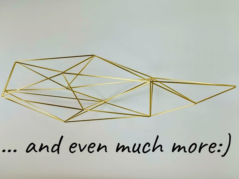 May include: A gold-colored wire sculpture featuring a complex geometric structure made of interconnected thin metal rods, forming a series of triangles and polygons. The text "... and even much more:)" is printed in black below the sculpture.