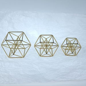 Three gold cuboctahedron ornaments