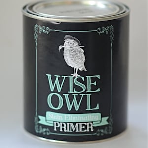 May include: A can of Wise Owl Stain Eliminating Primer paint. The can is black with a white owl wearing a beret and holding a paintbrush. The text "Wise Owl" is in teal green.
