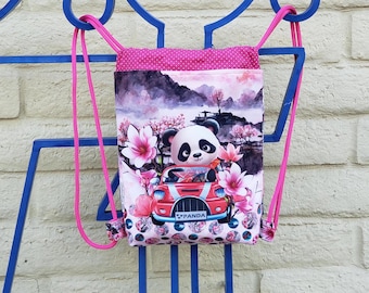 A Panda Bear backpack for kids, a red sports car, and pink Lotus flowers.
