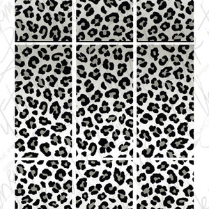 May include: Set of six leopard print press-on nails. The nails are white with a gradient of gray and black leopard spots. The text "Stick it to them" is written in black at the top of the image. The text "BESPOKE PRESS ON NAILS" is written in black below the first text. The text "STICKITTOTHEM.COM.AU" is written in black at the bottom of the image.