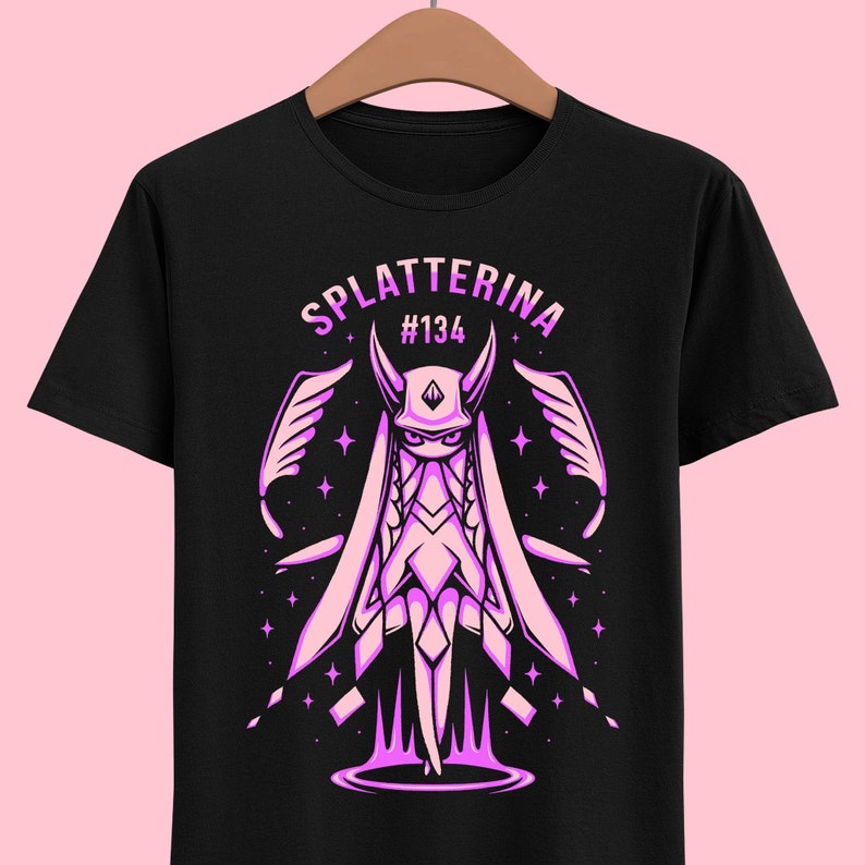 May include: Black t-shirt with a pink illustration of a character with wings and the text "Splatterina #134".