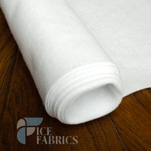 May include: A roll of white felt fabric with a soft, matte, and slightly fuzzy texture. The material is tightly wound, showing multiple layers of the white textile. The logo for ICE FABRICS is visible in the bottom left corner of the image.
