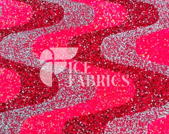 May include: Close-up of a fabric with a wavy pattern. The fabric is covered in sequins, with alternating sections of bright pink, dark red, and silver. The text "ICE FABRICS" is visible in the center.